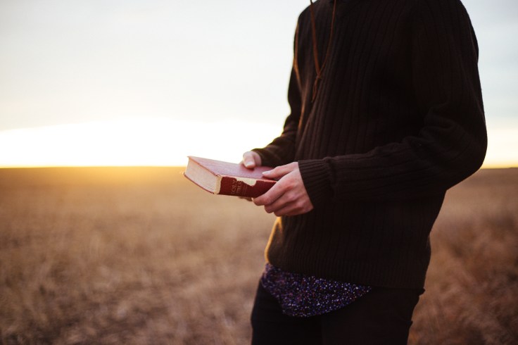 Man with Bible in Field